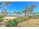 Community sand volleyball court with view of nearby lake and palm trees at 108 Emeraldview Ave, Davenport, FL 33897