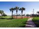 Community tennis court with palm trees and walkway at 108 Emeraldview Ave, Davenport, FL 33897