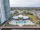 Resort-style pool with lounge chairs and palm trees at 241 Riverside Dr # 1203, Daytona Beach, FL 32117