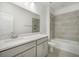 Bathroom with single vanity, gray cabinets and shower/tub combo at 2557 Village Lakes Blvd, Lakeland, FL 33805