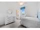 Bedroom with white dresser and a white bed with ruffles at 2557 Village Lakes Blvd, Lakeland, FL 33805