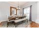 Dining room with wooden table, bench seating, and large mirror at 1046 Island Pointe Dr, Winter Garden, FL 34787