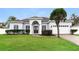 One-story home with gray exterior, white garage, and manicured lawn at 1046 Island Pointe Dr, Winter Garden, FL 34787