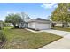 One-story home with attached garage and well-manicured lawn at 2003 Rocky Pointe Dr, Lakeland, FL 33813