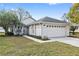 One story home with attached garage, landscaping and walkway at 2003 Rocky Pointe Dr, Lakeland, FL 33813