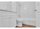 Clean bathroom with white vanity, toilet and tub at 803 E Valencia St, Lakeland, FL 33805