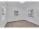 Bright bedroom with neutral carpeting and two windows at 803 E Valencia St, Lakeland, FL 33805