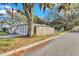 Side yard of the home with mature trees and a wooden fence at 803 E Valencia St, Lakeland, FL 33805