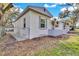 Side view of newly renovated home with fence and landscaping at 803 E Valencia St, Lakeland, FL 33805