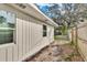 Rear view of the home, showcasing the backyard and fence at 803 E Valencia St, Lakeland, FL 33805