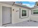 Gray front door entrance with light gray trim and small patio at 803 E Valencia St, Lakeland, FL 33805