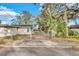 Side view of a newly renovated home with a fenced backyard and gate at 803 E Valencia St, Lakeland, FL 33805