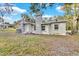 Newly renovated single story home with a gray painted exterior and a brick chimney at 803 E Valencia St, Lakeland, FL 33805