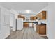 Kitchen boasts wood cabinets, granite counters, and white appliances at 803 E Valencia St, Lakeland, FL 33805