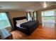 Main bedroom with hardwood floors, access to deck at 4200 Joslyn Ln, Lady Lake, FL 32159