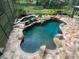 Irregular shaped pool with a waterfall feature at 4200 Joslyn Ln, Lady Lake, FL 32159