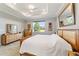 Main bedroom with wood furniture and large window with a view at 9849 Sw 99Th Loop, Ocala, FL 34481