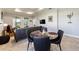 Round glass dining table with four black chairs in a bright dining area at 9849 Sw 99Th Loop, Ocala, FL 34481