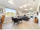 Bright dining area with a glass table and black chairs, overlooking the backyard at 9849 Sw 99Th Loop, Ocala, FL 34481