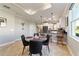 Dining area with a round glass table and four black chairs near kitchen at 9849 Sw 99Th Loop, Ocala, FL 34481