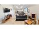 Living room boasts a leather sofa and a view into the kitchen at 9849 Sw 99Th Loop, Ocala, FL 34481