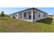Home backyard featuring a covered patio and lush lawn, great for outdoor enjoyment at 1258 Lakeridge Way, Lake Alfred, FL 33850