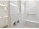 Bathroom featuring a walk-in shower with a built-in bench and tiled walls at 1258 Lakeridge Way, Lake Alfred, FL 33850
