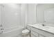 Modern bathroom features a tub, sleek vanity, and white subway tile for a clean and stylish look at 1258 Lakeridge Way, Lake Alfred, FL 33850