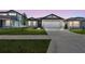 Charming single-story home with a well-manicured lawn, modern garage door, and inviting curb appeal at sunset at 1258 Lakeridge Way, Lake Alfred, FL 33850