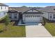 Charming single-story home with a manicured lawn, two car garage, and a concrete driveway at 1258 Lakeridge Way, Lake Alfred, FL 33850