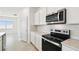 Stainless steel appliances, white cabinetry, and bright natural light in the kitchen at 1258 Lakeridge Way, Lake Alfred, FL 33850