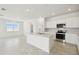 Bright kitchen featuring an island, stainless steel appliances, and lots of natural light at 1258 Lakeridge Way, Lake Alfred, FL 33850