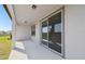 Covered patio offers an outdoor living space with sliding glass doors, perfect for relaxing or entertaining at 1258 Lakeridge Way, Lake Alfred, FL 33850