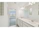 Modern bathroom featuring double vanity sinks, quartz countertop, and large mirrors at 1622 Ruby Ln, Lake Alfred, FL 33850