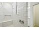 Stylish bathroom with a walk-in shower featuring white subway tile and a built-in bench at 1622 Ruby Ln, Lake Alfred, FL 33850