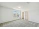 Spacious bedroom with carpet, natural lighting, a closet and doors leading to other rooms at 1622 Ruby Ln, Lake Alfred, FL 33850