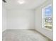 Bright room with tile flooring and natural light from a window overlooking the neighborhood at 1622 Ruby Ln, Lake Alfred, FL 33850