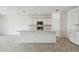 Bright, open kitchen featuring an island, stainless steel appliances, and white cabinetry at 1622 Ruby Ln, Lake Alfred, FL 33850