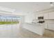 Open concept kitchen with stainless steel appliances, center island, and sliding glass doors to the backyard at 1622 Ruby Ln, Lake Alfred, FL 33850