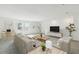 Bright living room features neutral walls, plush carpet, and contemporary furniture for a cozy and inviting space at 1622 Ruby Ln, Lake Alfred, FL 33850