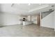 Spacious open-concept living area with a large kitchen island and staircase at 1622 Ruby Ln, Lake Alfred, FL 33850