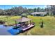 Aerial view of home with dock and gazebo on the lake at 4680 Poinciana Dr, Indian Lake Estates, FL 33855