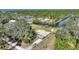 Aerial view of the house and property with canal access at 4680 Poinciana Dr, Indian Lake Estates, FL 33855
