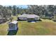 Home with shed and sunroom addition at 4680 Poinciana Dr, Indian Lake Estates, FL 33855