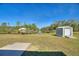 Spacious backyard with canal view, shed, and gazebo at 4680 Poinciana Dr, Indian Lake Estates, FL 33855