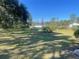 Spacious backyard with lush lawn and American flag at 4680 Poinciana Dr, Indian Lake Estates, FL 33855
