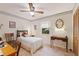 Cozy bedroom featuring natural light, a ceiling fan and a comfortable bed at 4680 Poinciana Dr, Indian Lake Estates, FL 33855