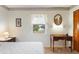 Bedroom with water view, wooden desk, and double bed at 4680 Poinciana Dr, Indian Lake Estates, FL 33855