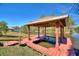 Waterfront property featuring a covered boat dock, perfect for lakeside living at 4680 Poinciana Dr, Indian Lake Estates, FL 33855