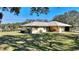 Single-story home with carport and large backyard at 4680 Poinciana Dr, Indian Lake Estates, FL 33855